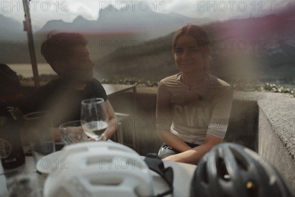 Young man taking a coffee break while riding his racing bike on Lake Garda. Sunny weather and dolce vita