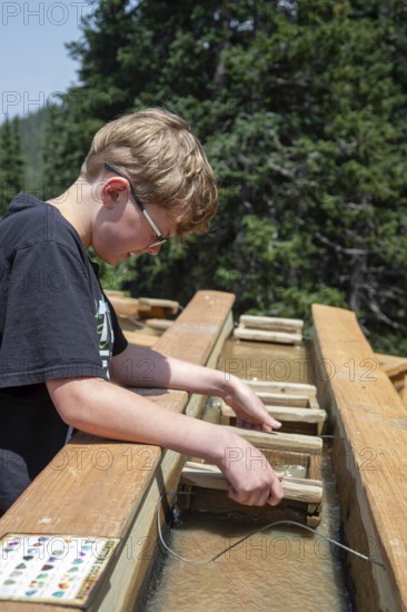 Colorado Springs, Colorado - A sluice along the highway to the Pikes Peak summit offers tourists a chance to mine for gemstones