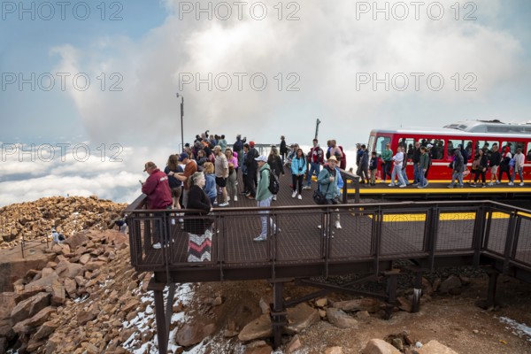 Colorado Springs, Colorado - Arriving passengers on the Manitou and Pikes Peak Railway flock to the viewing platform at the 14, 115-foot summit of Pikes Peak