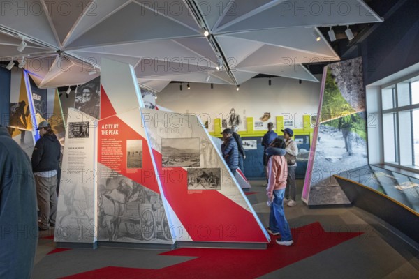 Colorado Springs, Colorado - Tourists view displays in the Summit Visitor Center at Pikes Peak, a 14, 115' mountain in Colorado's front range. Thousands of tourists visit, most by driving a steep road to the summit, or riding on a cog railway