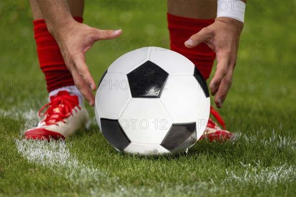 (Photomontage, ball replaced) Footballer prepares the ball for a corner kick