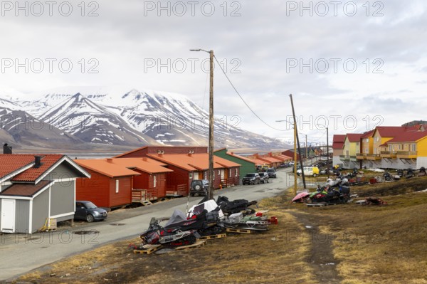 Colourful wooden houses, street, skidoos, Longyearbyen, Spitsbergen, Svalbard