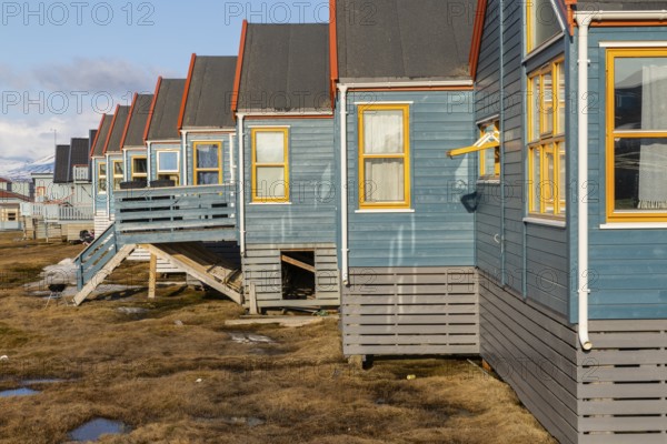 Colourful houses with exposed supply lines, Longyearbyen, Spitsbergen, Svalbard