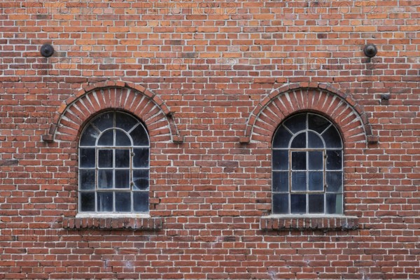 Old windows in a traditional brick wall with rustic charm and visible reflections, Stiftsmühle, Ochtrup-Langenhorst, Münsterland, North Rhine-Westphalia, Germany