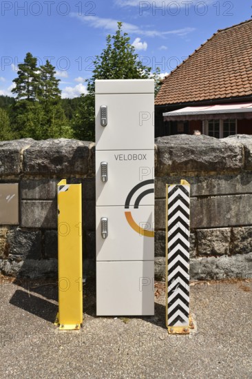 Forbach, Germany - July 12th 2025: Modern Velobox e-bike charging station with secure lockers installed in scenic outdoor location