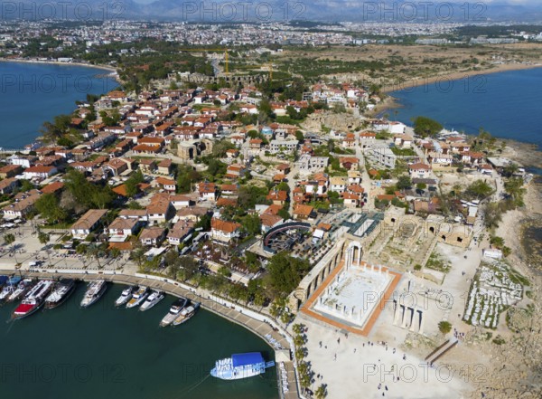 Picturesque view of a coastal town with ancient ruins and red roofs by the sea, aerial view, harbour and Temple of Apollo, Side, Manavgat, Antalya province, Turkey