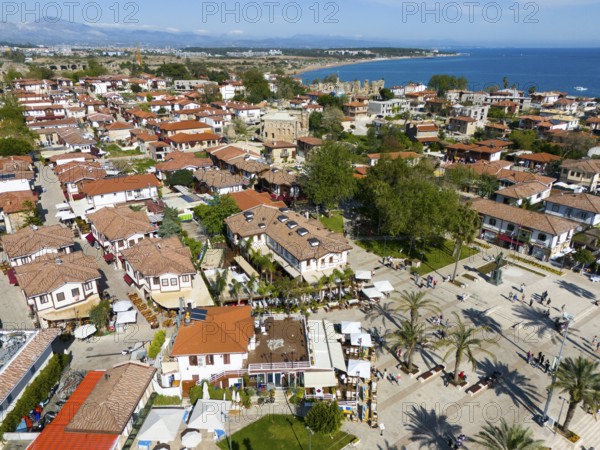 View of a Mediterranean town with red houses, palm trees and coastal view, aerial view, Side, Manavgat, Antalya province, Turkey