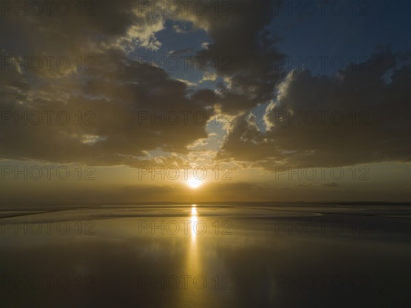 A calm sunset over a lake with golden coloured sky and clouds, aerial view, salt lake, Tuz Gölü, location between Konya, Aksaray and Ankara, Turkey