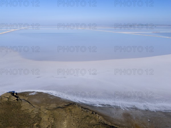 A tranquil salt landscape under a clear sky, minimalist and expansive, aerial view, salt lake, Tuz Gölü, location between Konya, Aksaray and Ankara, Turkey