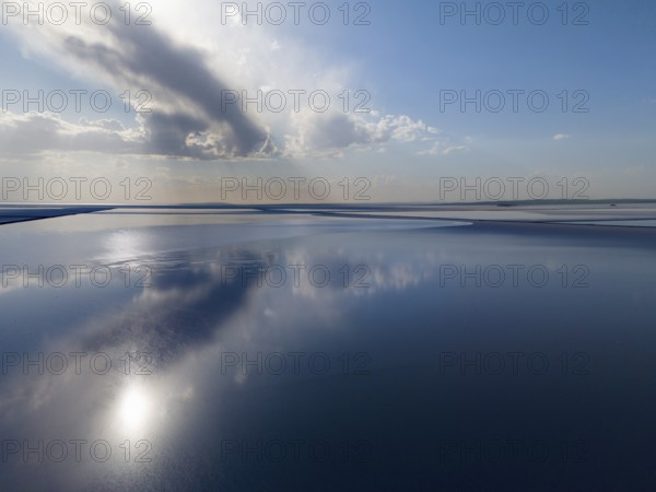 Fascinating lake landscape with calm water that reflects the sky and clouds, radiates peace and space, aerial view, salt lake, Tuz Gölü, location between Konya, Aksaray and Ankara, Turkey