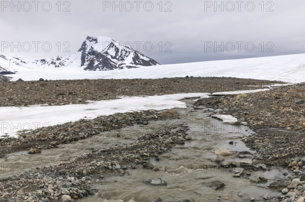 Melting glacier, stones, water, mountain peak, Cooper Camp, Spitsbergen, Svalbard
