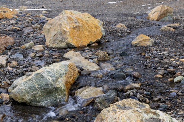 Melting glacier, stones, water, Cooper Camp, Spitsbergen, Svalbard