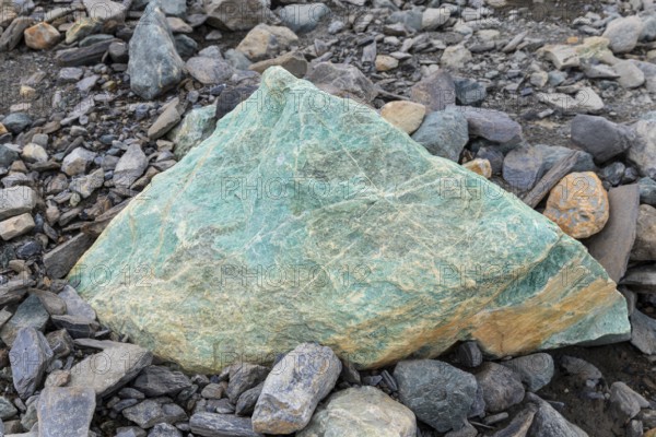Melting glacier, copper-bearing stone, Cooper Camp, Spitsbergen, Svalbard