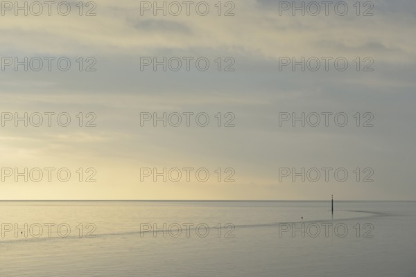 Wadden Sea at rising water, stone groyne with sea mark, North Sea, Norddeich, Lower Saxony, Germany