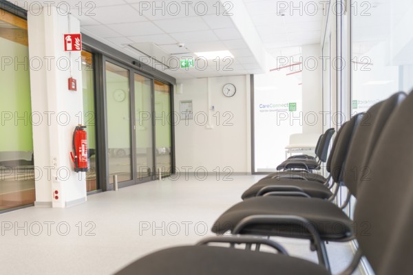 Modern corridor with chairs and escape signs in bright surroundings, Care Connect, vaccination kiosk for refugees, Calw, Germany