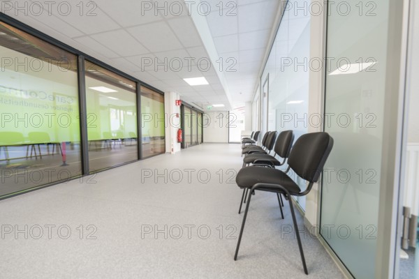 Modern, bright hallway with chairs and glass doors in the waiting area, Care Connect, vaccination kiosk for refugees, Calw, Germany