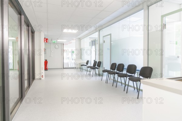 Modern and bright corridor with waiting area and glass walls, Care Connect, vaccination kiosk for refugees, Calw, Germany
