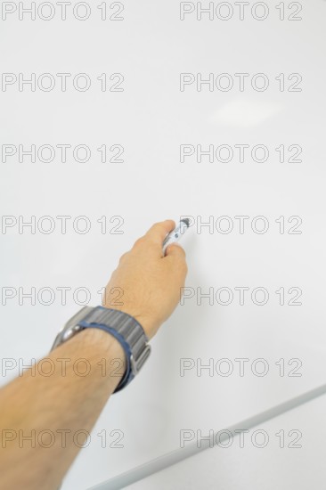 Close-up of a hand with a pen on a blackboard, Care Connect, vaccination kiosk for refugees, Calw, Germany