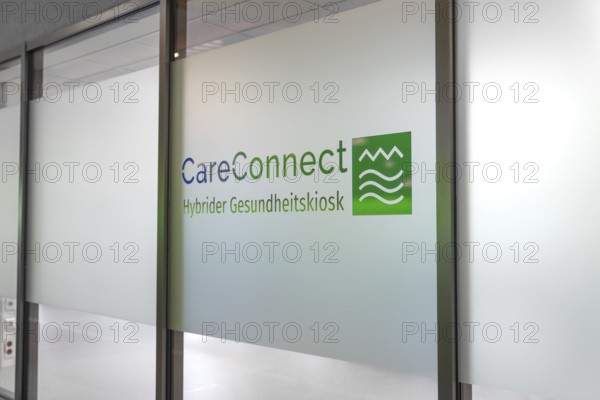 Glass wall with CareConnect logo in modern design and health kiosk lettering, Care Connect, vaccination kiosk for refugees, Calw, Germany