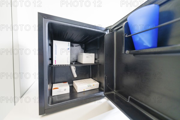 Open freezer with several medicine boxes in the office, Care Connect, vaccination kiosk for refugees, Calw, Germany