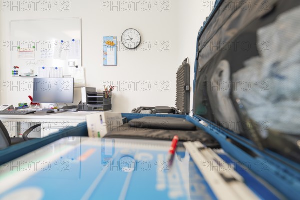 Modern office space with desk, monitor and wall clock, Care Connect, vaccination kiosk for refugees, Calw, Germany