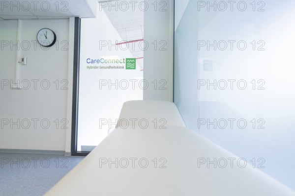 Practice room with couch and glass wall in a bright, modern style, Care Connect, vaccination kiosk for refugees, Calw, Germany