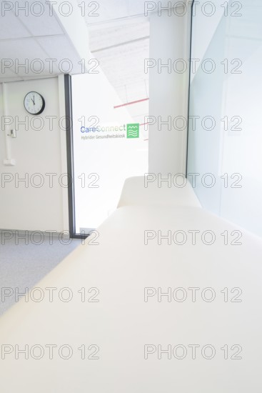 Treatment room with couch and CareConnect logo in minimalist style, Care Connect, vaccination kiosk for refugees, Calw, Germany