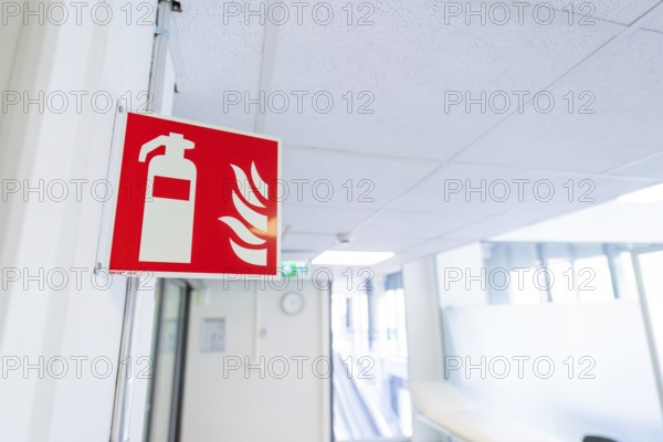 Safety sign for fire extinguisher installed in an office corridor, Care Connect, vaccination kiosk for refugees, Calw, Germany