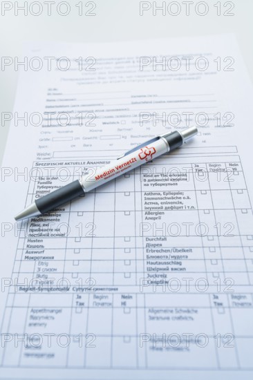 Biros on a completed form on a desk, Care Connect, vaccination kiosk for refugees, Calw, Germany