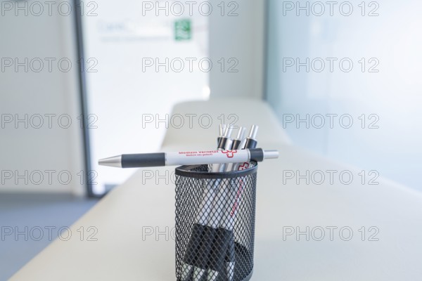 Pen holder with pens on a desk in a modern office, Care Connect, vaccination kiosk for refugees, Calw, Germany