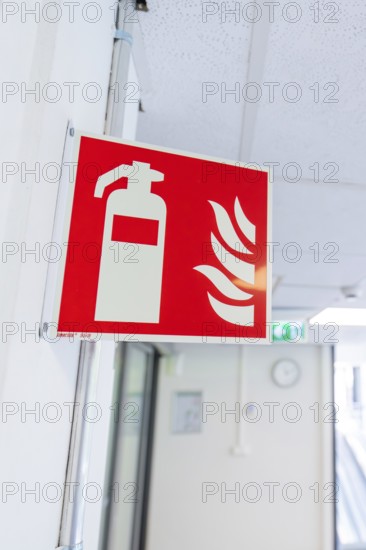 Fire extinguisher sign in an office corridor as a safety instruction, Care Connect, vaccination kiosk for refugees, Calw, Germany