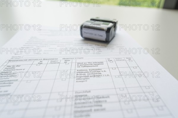 A completed form with a stamp on it, Care Connect, vaccination kiosk for refugees, Calw, Germany