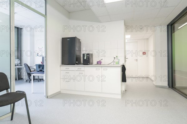 Modern kitchenette in the office with white cupboards and appliances, Care Connect, vaccination kiosk for refugees, Calw, Germany