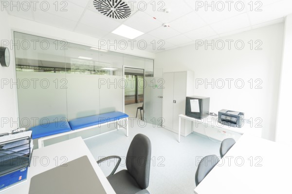 A bright examination room with couch and desk, Care Connect, vaccination kiosk for refugees, Calw, Germany