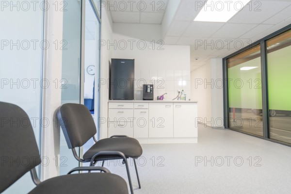 A modern waiting room with chairs and large windows, Care Connect, vaccination kiosk for refugees, Calw, Germany