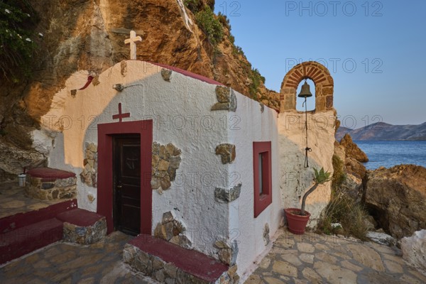 Legend, crab, shell fisherman, coastal chapel with arch and bell, surrounded by rocks and seascape, chapel, small church, Agia Kavouradena Monastery, Xirokambos, Leros, Dodecanese, Greek Islands, Greece