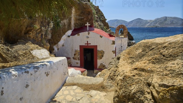 Legend, Crab, Mussel fisherman, Beautiful chapel on the rocky Mediterranean coast in sunny weather, Characteristic red roof, Chapel, Little church, Agia Kavouradena Monastery, Xirokambos, Leros, Dodecanese, Greek Islands, Greece