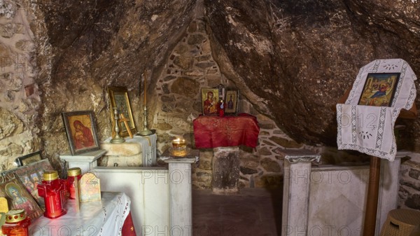 Legend, Crab, Mussel fisherman, Small chapel interior with candles and religious icons on a stone display, Chapel, Little church, Agia Kavouradena Monastery, Xirokambos, Leros, Dodecanese, Greek Islands, Greece
