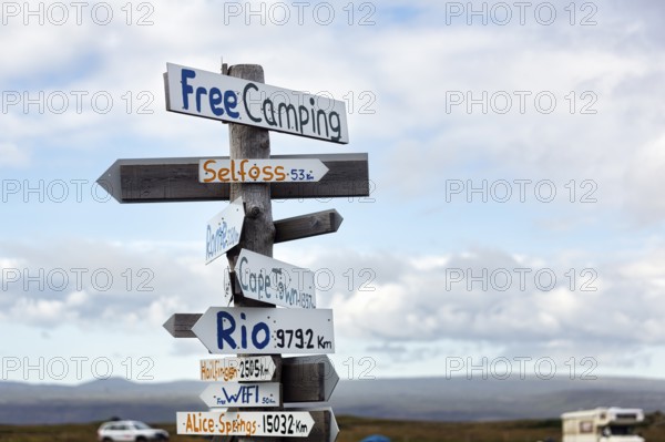 Signposts, signs, free camping, free WIFI, distance to Selfoss, Cape Town, Rio and Alice Springs, campsite in Selvogur, South Coast, Iceland