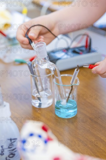 Chemistry experiment with liquids and electrodes on a table, Battery Research, Nagold, Germany