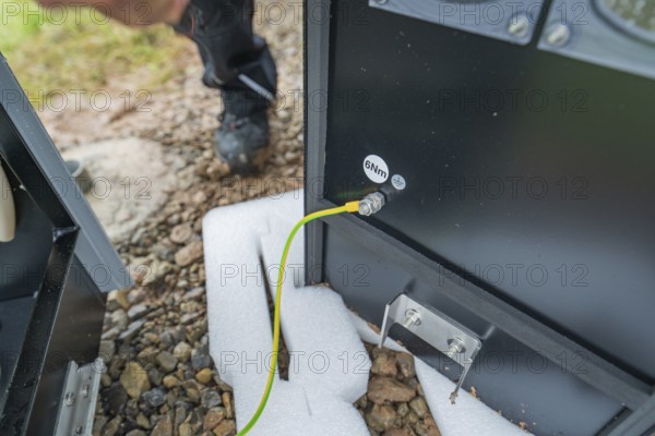 Close-up of an electrical connection with a yellow cable and spanner, assembly of a charging station for electric cars, Calw, Germany