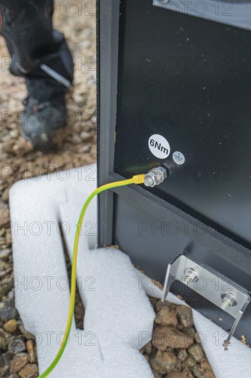 Underground cables are attached to a device and secured to the ground, installation of a charging station for electric cars, Calw, Germany