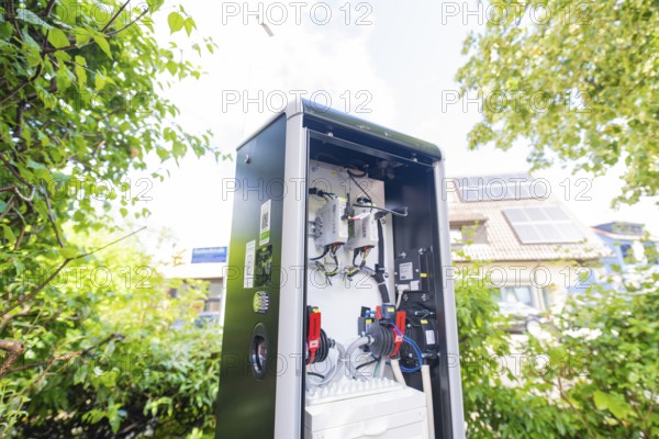 Open outdoor electrical system between trees with solar system in the background, installation of a charging station for electric cars, Calw, Germany