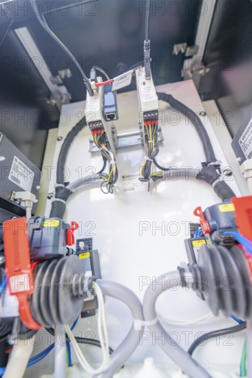 Close-up of the wiring and devices inside an electrical enclosure, assembly of a charging station for electric cars, Calw, Germany