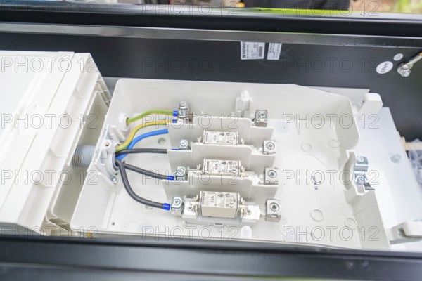 Interior view of a switch box with organised cables and fuses, installation of a charging station for electric cars, Calw, Germany