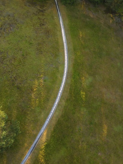 Close-up of a curved path across a green meadow, Retro Freizeitpark Poppeltal Riesenrutschbahn, Enzklösterle, Black Forest, Germany