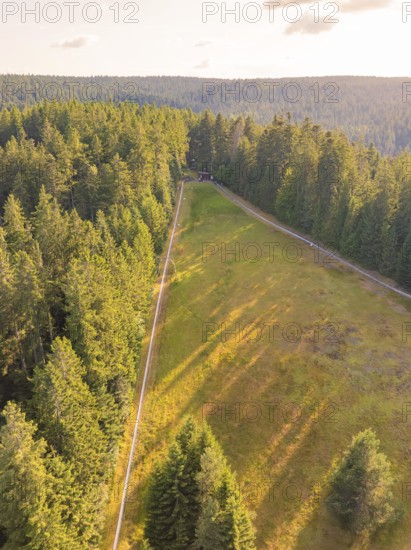 Aerial view of a green forest with open clearing, surrounded by dense nature, Retro Freizeitpark Poppeltal Riesenrutschbahn, Enzklösterle, Black Forest, Germany