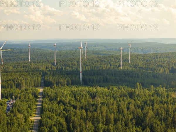 Wind turbines in a wide forest landscape under a cloudy sky, Simmersfeld, Black Forest, Germany