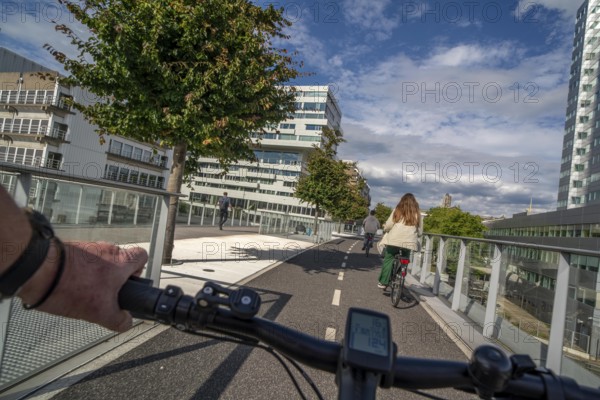 Cycling over the Moreelsebrug, pedestrian and cyclist bridge over the tracks of Utrecht Centraal, Central Station, Rabobank