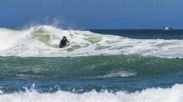 Surfer riding a wave on Contis beach, Saint Julien en Born, Saint-Julien-en-Born, Landes, France